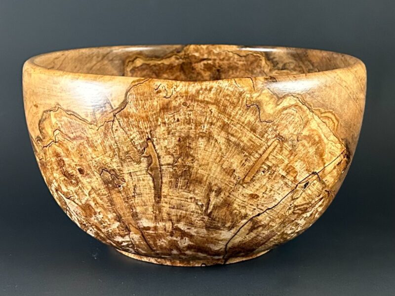 Figured deep bowl. Deep wooden bowl with dense branching grain patterns across its front.
