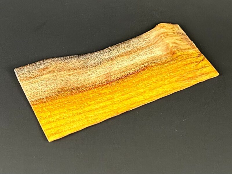 Rectangular tray. Long rectangular wooden tray with raised ends and golden striped grain.