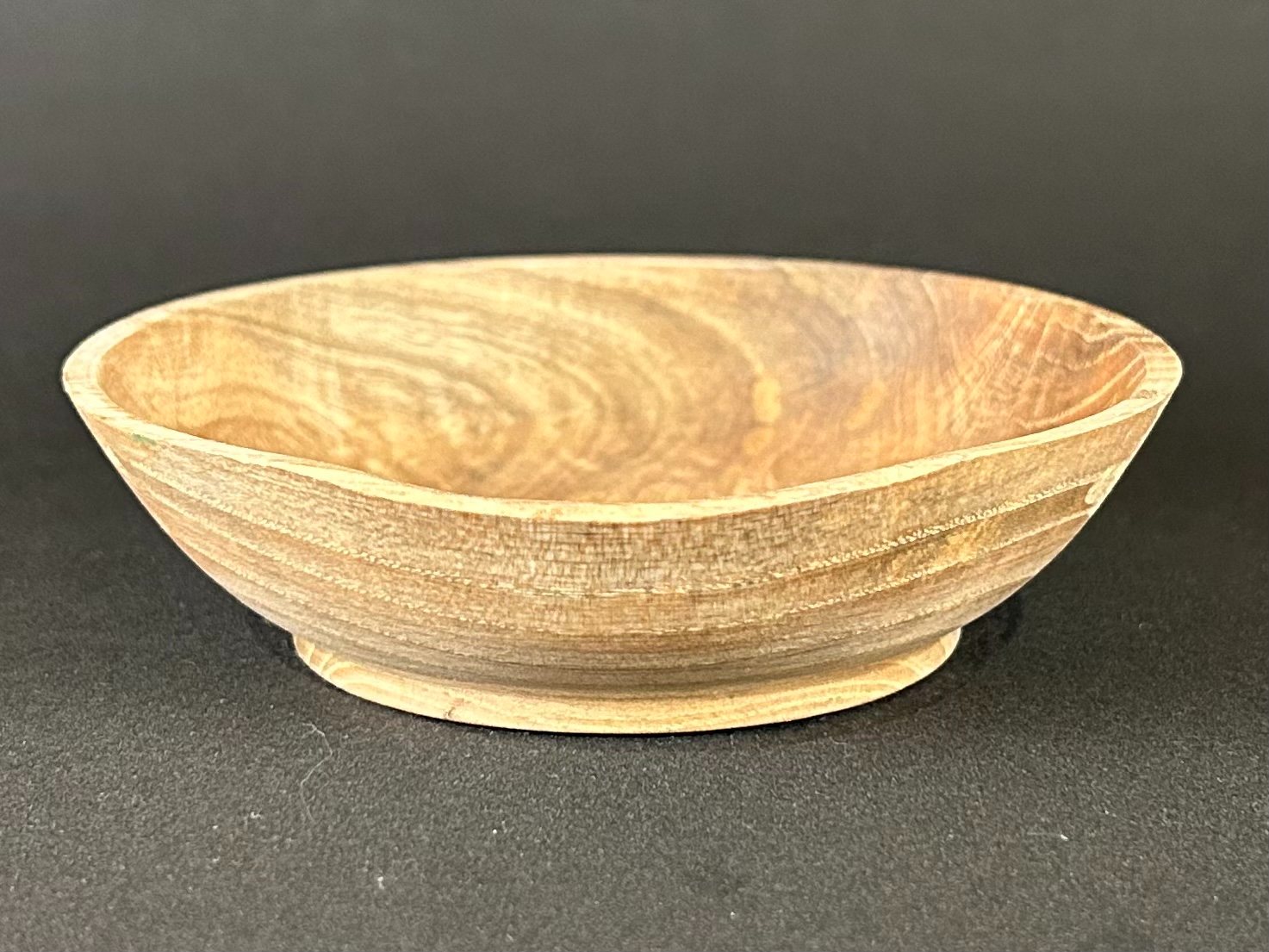 Pale footed bowl. Pale wooden bowl with flared sides and a small rounded foot.