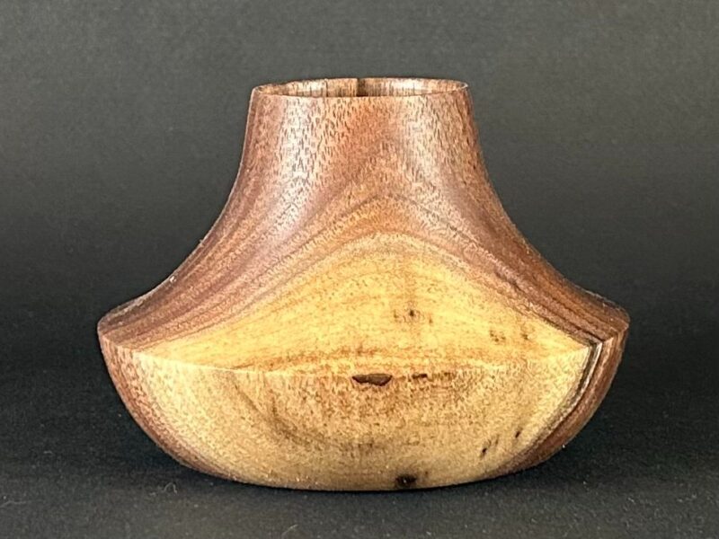 Flared vessel. Low wooden vessel with flared shoulders and a narrow neck.