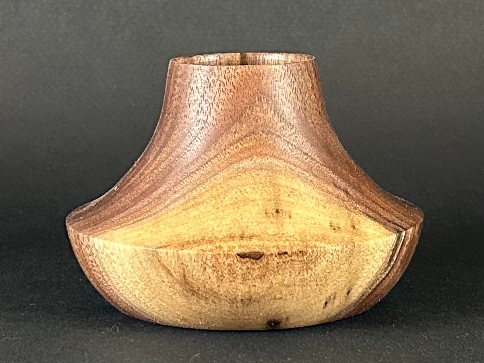 Flared vessel. Low wooden vessel with flared shoulders and a narrow neck.