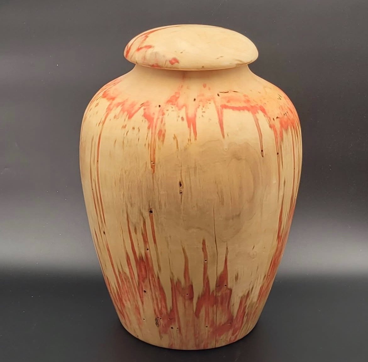 Lidded vessel. Pale lidded wooden vessel with red-toned markings.