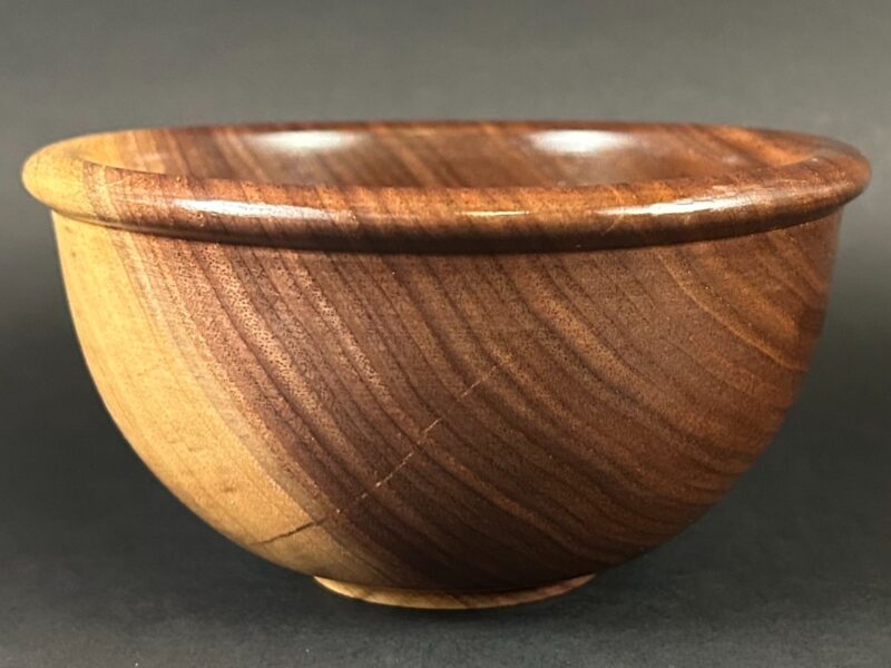 Rolled-rim bowl. Brown wooden bowl with a rounded projecting rim.