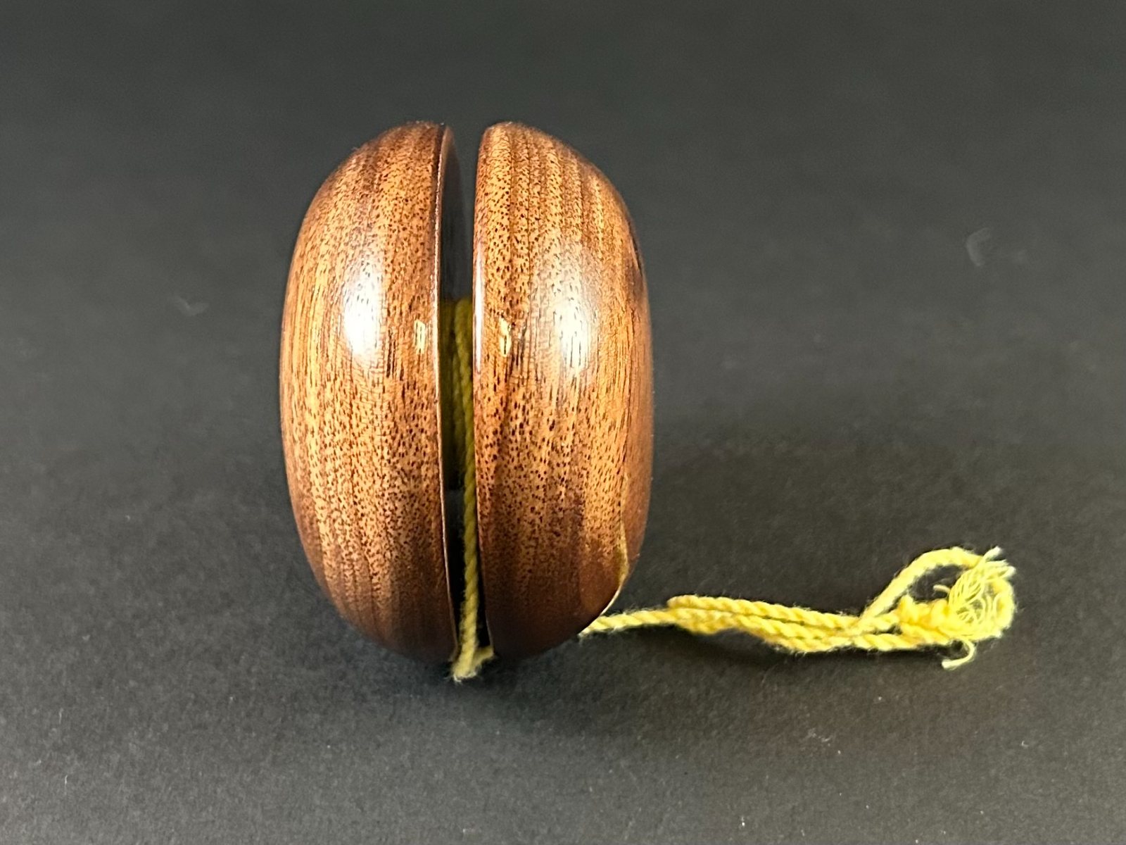 Wooden yo-yo. Side view showing the groove between the two wooden faces.