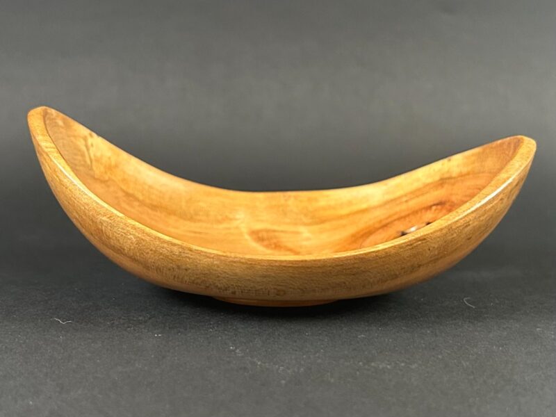 Sweeping-edge bowl. Golden bowl with two raised ends and a low sweeping center.