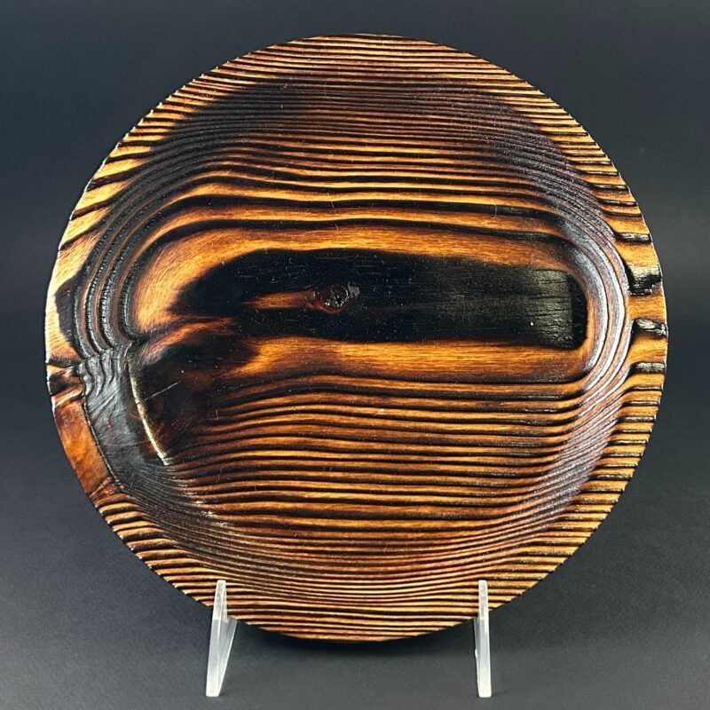 Patterned platter. Round platter on a stand with bold dark and golden bands.