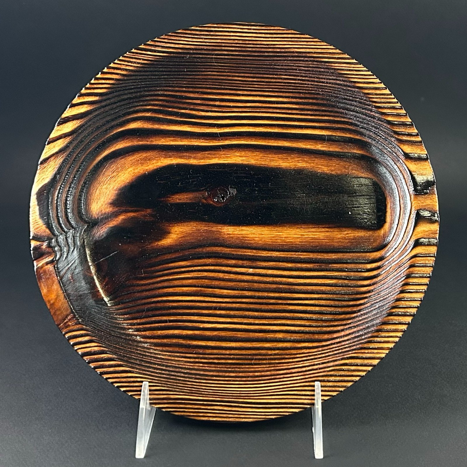 Patterned platter. Round platter on a stand with bold dark and golden bands.