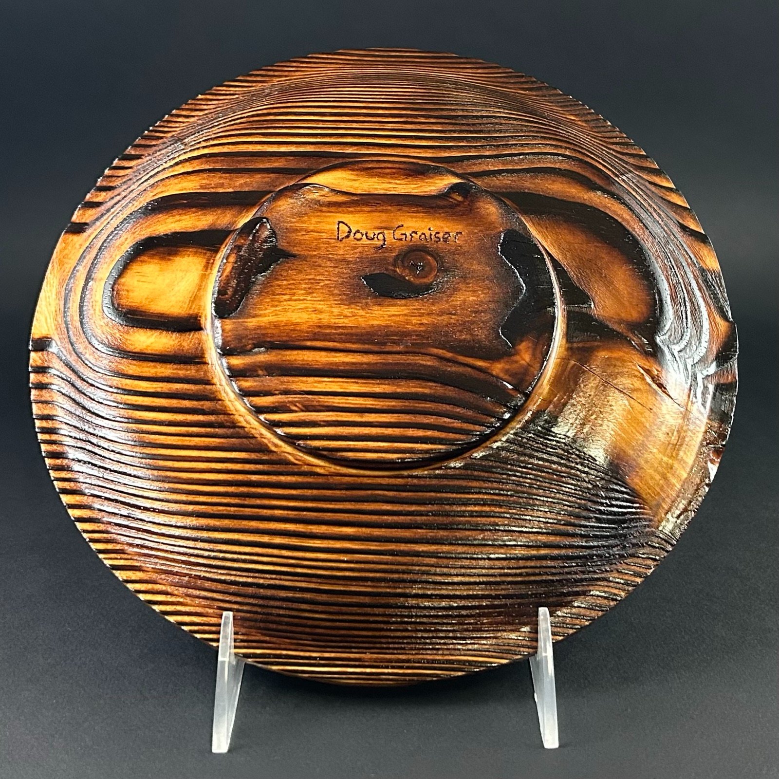 Patterned platter. Other face of the platter on its display stand.
